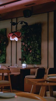 A sophisticated restaurant interior featuring floral wall decorations and ambient lighting.