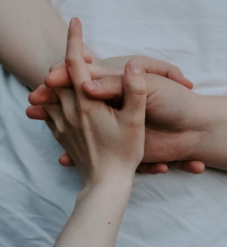 Close Up Of Three Hands Holding 