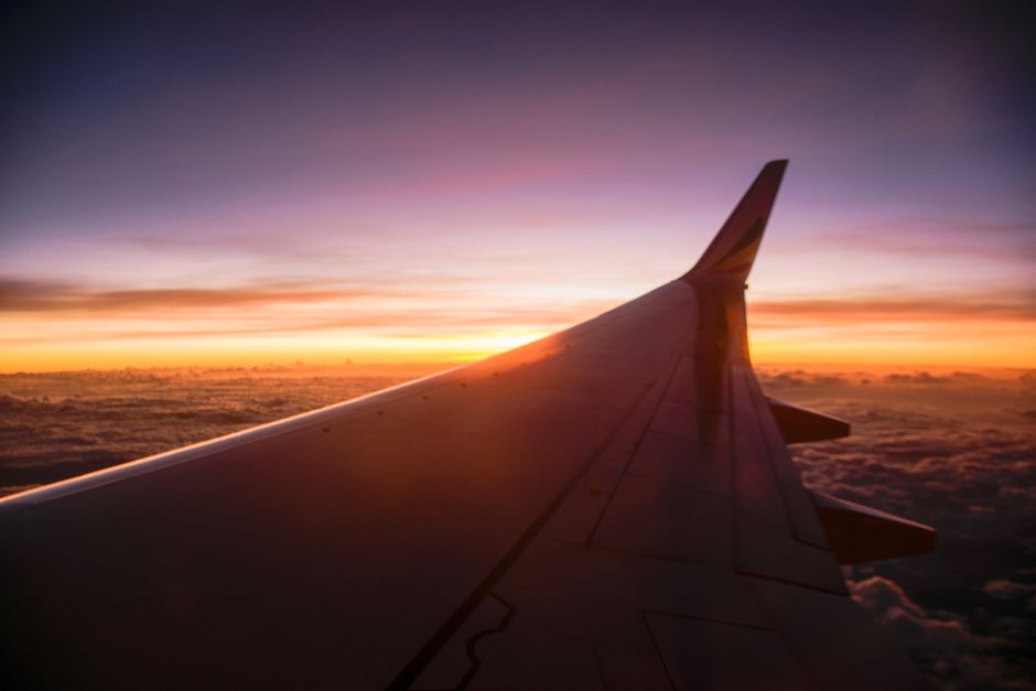 airplane wing over a sunset during a budget flight airplane wing over a sunset during a budget flight