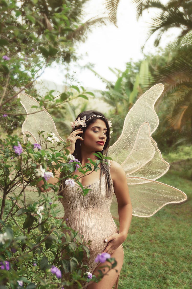 Woman In Garden Wearing Butterfly Costume