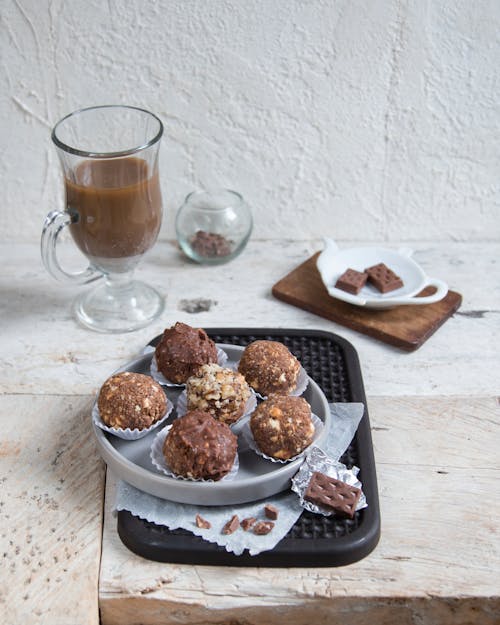 A Chocolate Balls Near the Hot Chocolate on Clear Glass