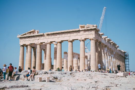 Tourists visiting the iconic Parthenon at the Acropolis in Athens, Greece on a sunny day.