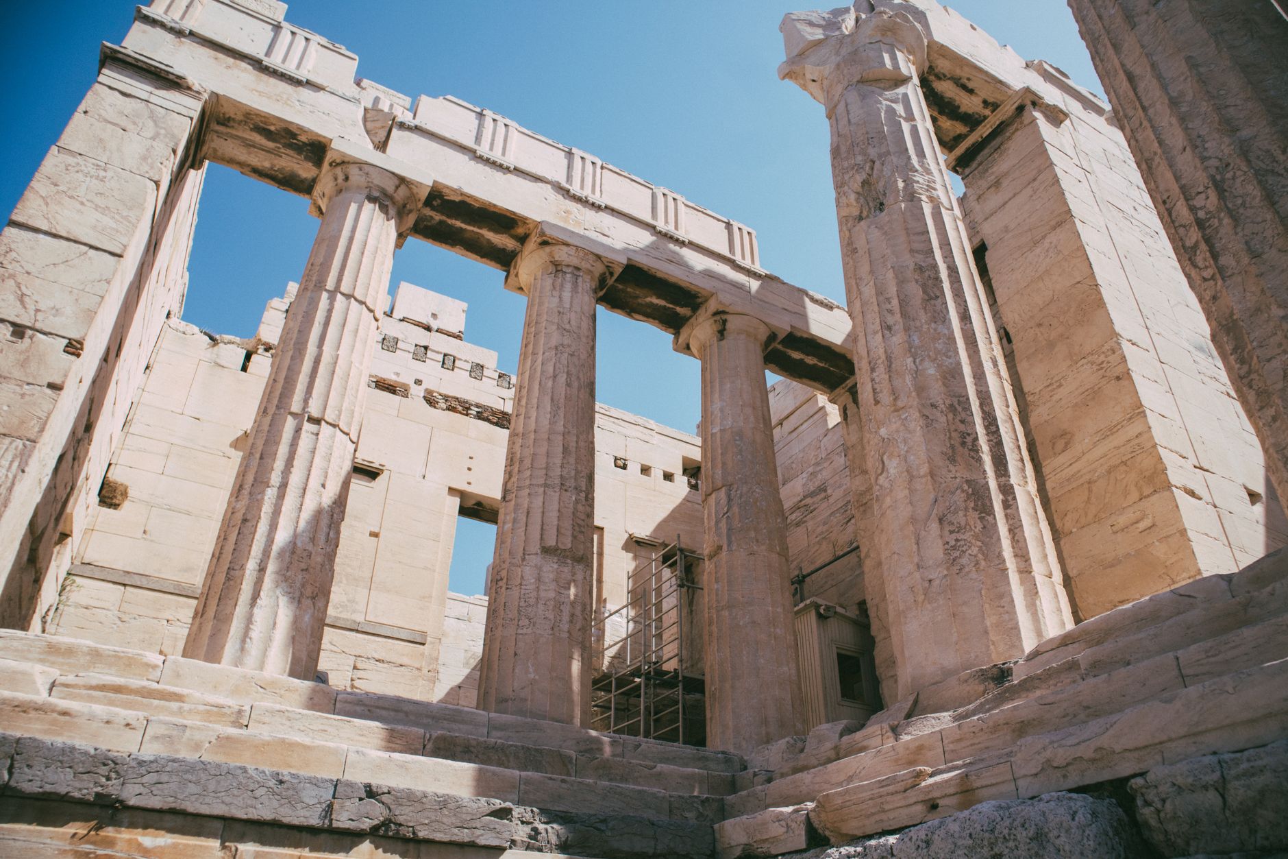 Cultural heritage of ancient Greek architecture with stunning columns under a clear blue sky.