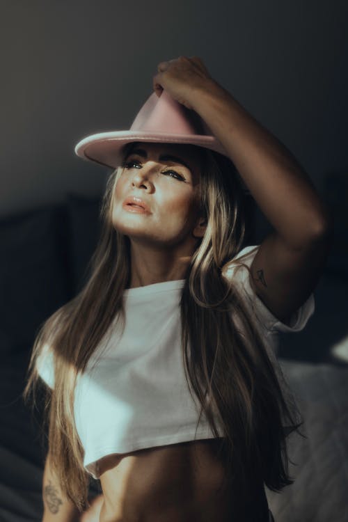 Woman in White Crop Top Wearing a Hat