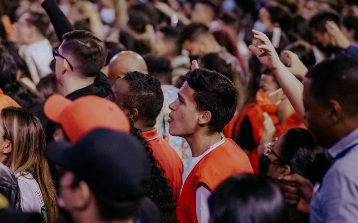 Vibrant and packed audience enjoying a live music performance at a nighttime concert event.