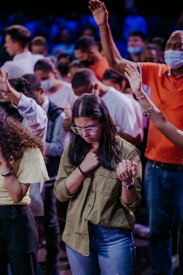 People Raising Their Hands In An Audience 