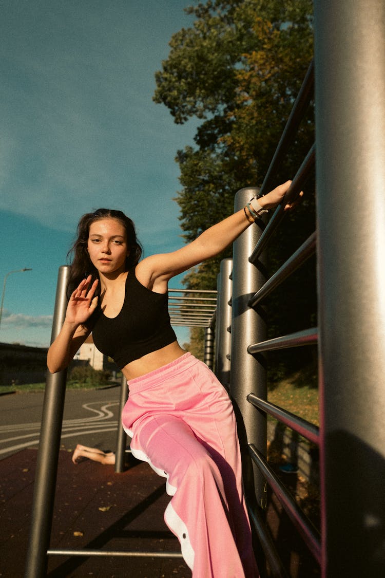 Young Woman Holding A Barrier And Leaning 