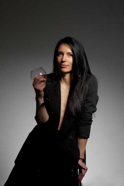 Woman in Black Blazer Holding a Wine Glass 