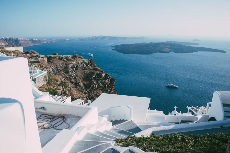 Traditional white Santorini buildings beside the sea