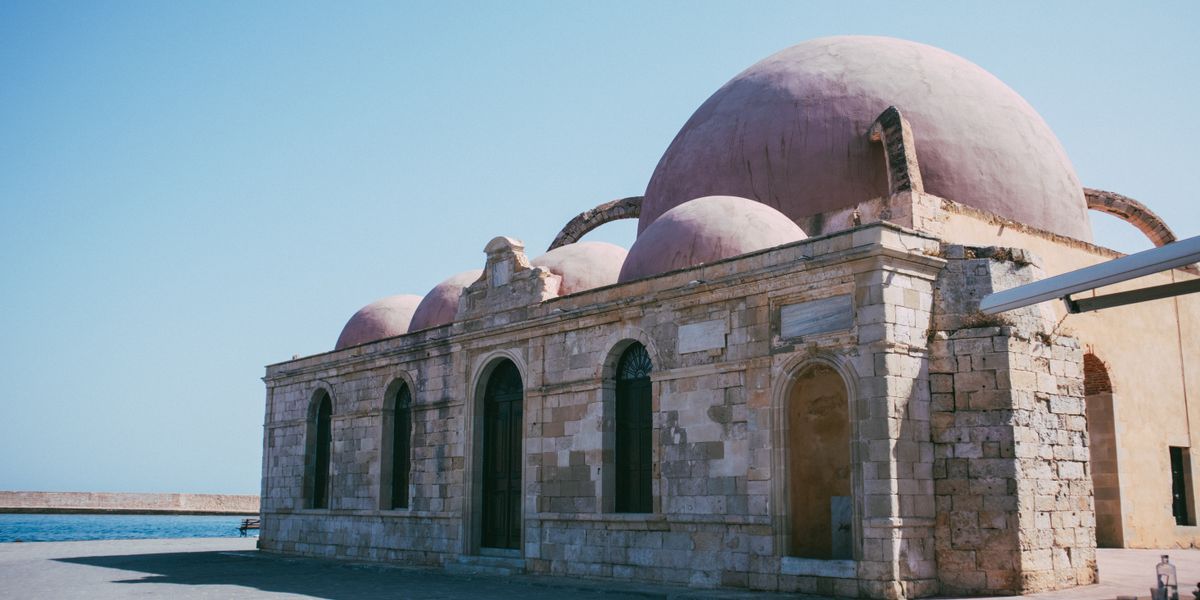 A domed Ottoman-era mosque beside the sea in a Cretan harbour town