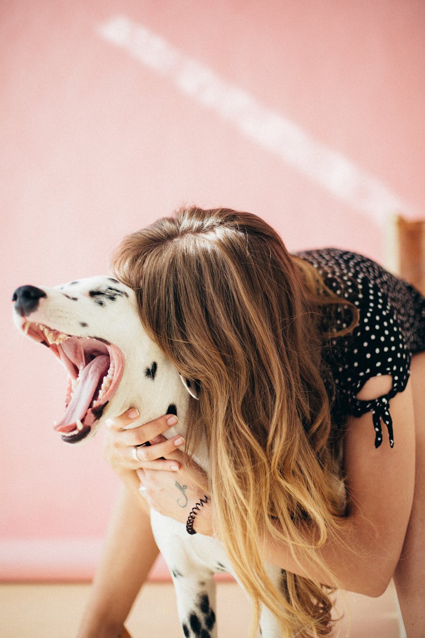 how to clean your dog's teeth naturally. a woman playing with her dog