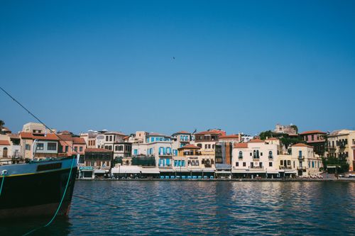 Free Scenic view of a charming harbor town with colorful buildings and clear skies, showcasing a picturesque waterfront. Stock Photo