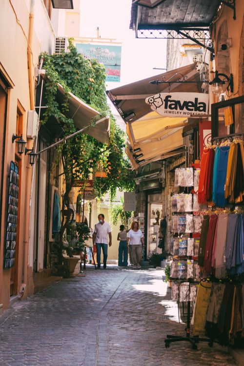 Free A lively cobblestone alley featuring souvenir shops and vibrant market stalls in summer. Stock Photo