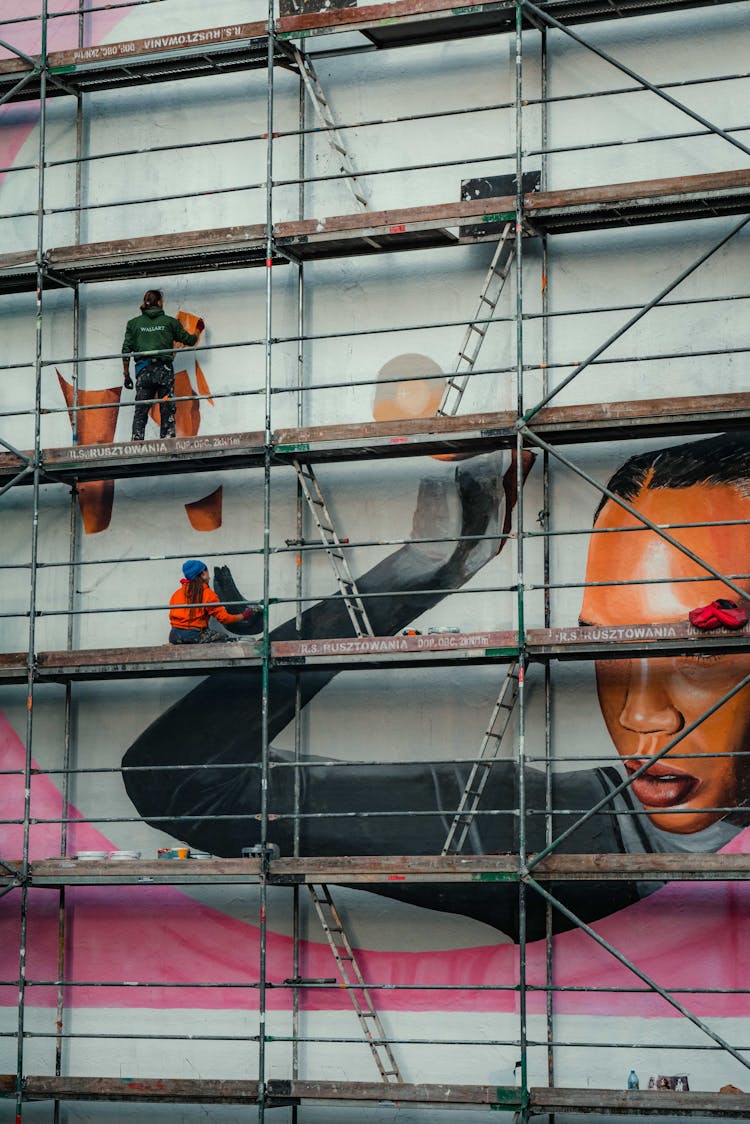 An Artist Painting A Mural