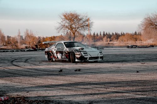 Free A sports car executing an intense drift maneuver in an open outdoor setting in Turkey. Stock Photo