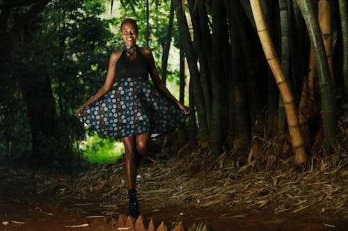 Woman Smiling While Holding Her Blue Polka Dots Skirt