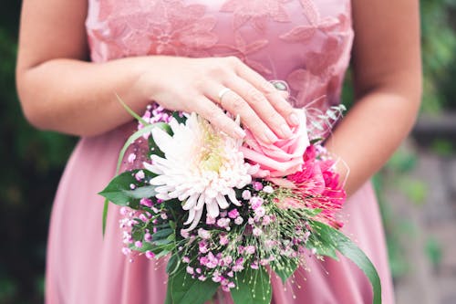 Close-Up Shot of a Woman Holding a Bridal Bouquet