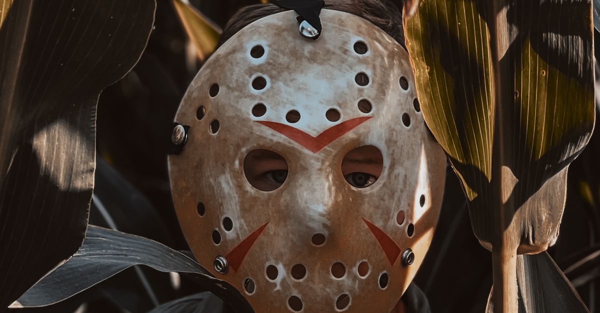 A Boy in a Jason Voorhees Halloween Mask Standing in a Corn Field ...