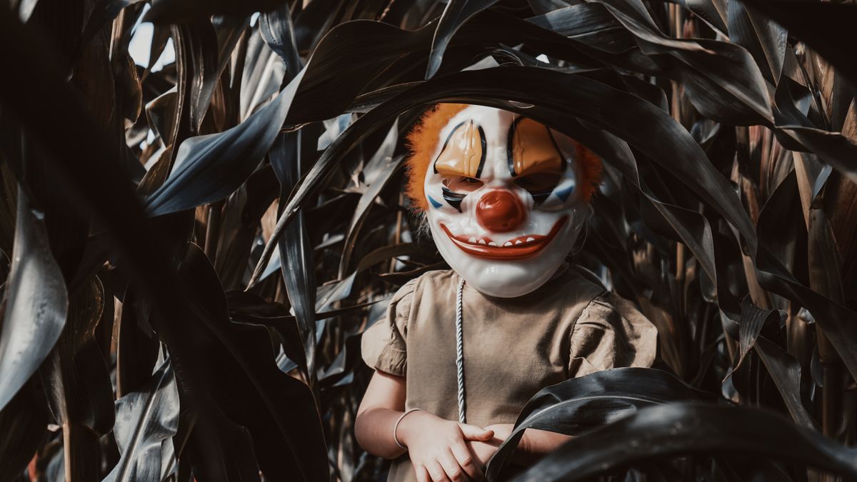 Creepy masked figure in cornfield evoking classic 80s horror movie villain imagery