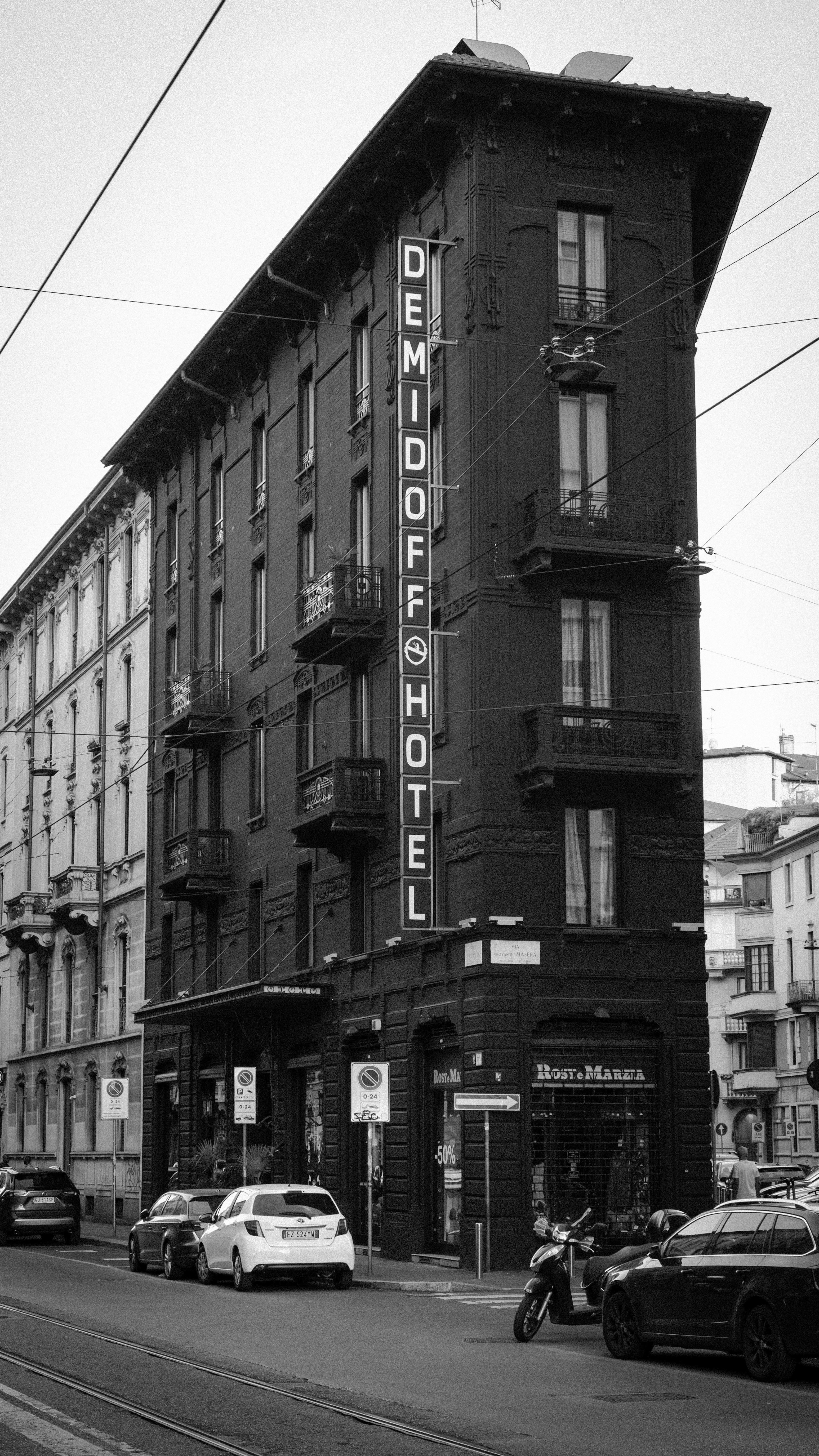 Historic Demidoff Hotel facade in Milan, Italy - urban architectural beauty.