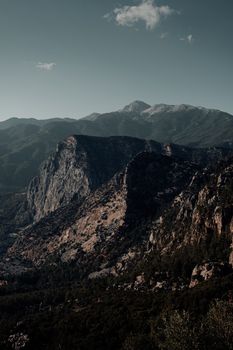 A breathtaking view of rugged mountains with deep shadows under a clear sky.