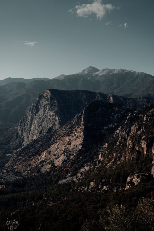 Free A breathtaking view of rugged mountains with deep shadows under a clear sky. Stock Photo