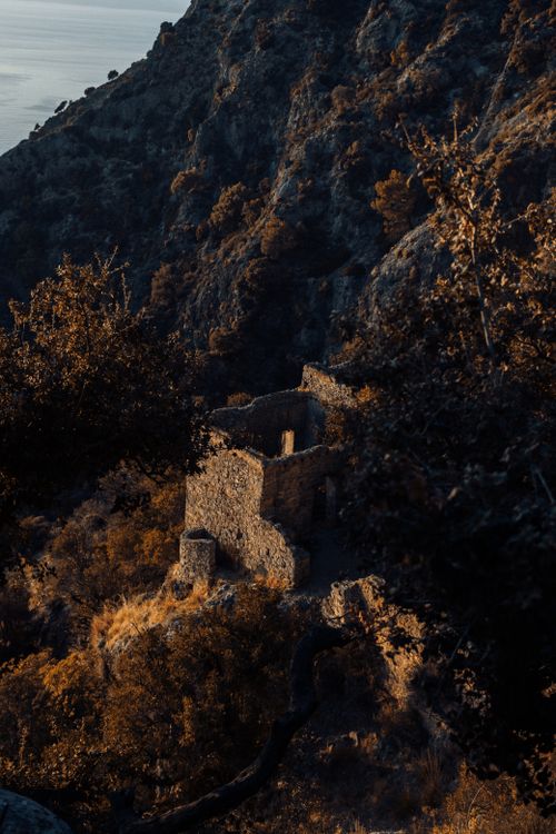 Free Explore ancient stone ruins nestled in a dramatic mountainous landscape at twilight. Stock Photo