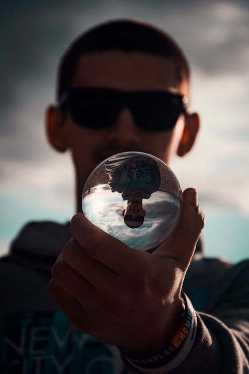 Person Holding Crystal Ball