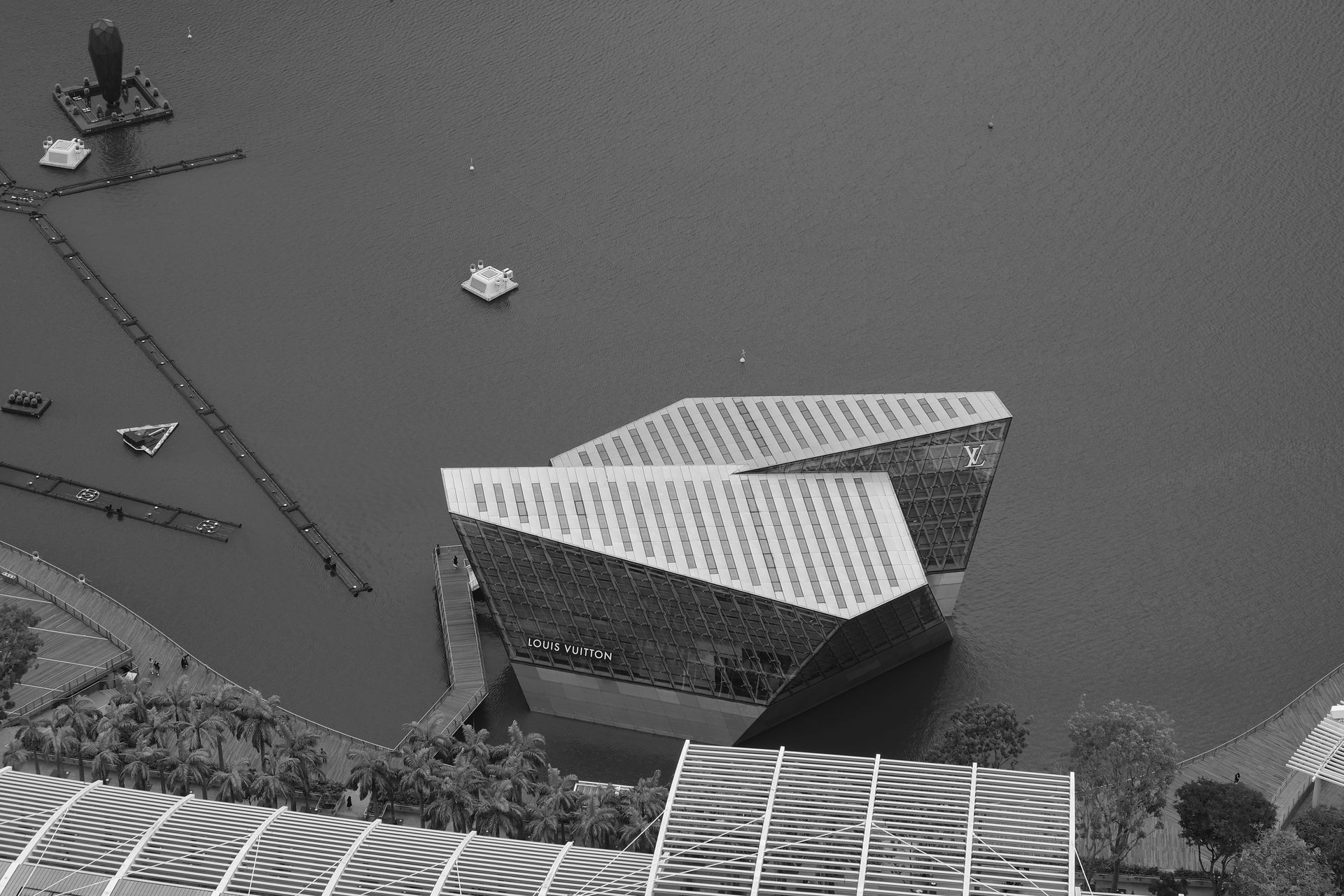 Black and white aerial view of the Louis Vuitton Island Store in Marina Bay, Singapore.