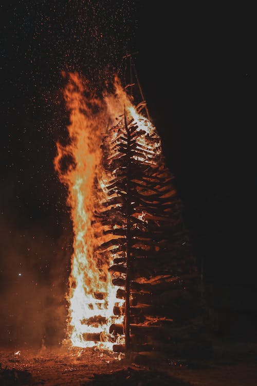 View of a Burning Wooden Tower at Night 