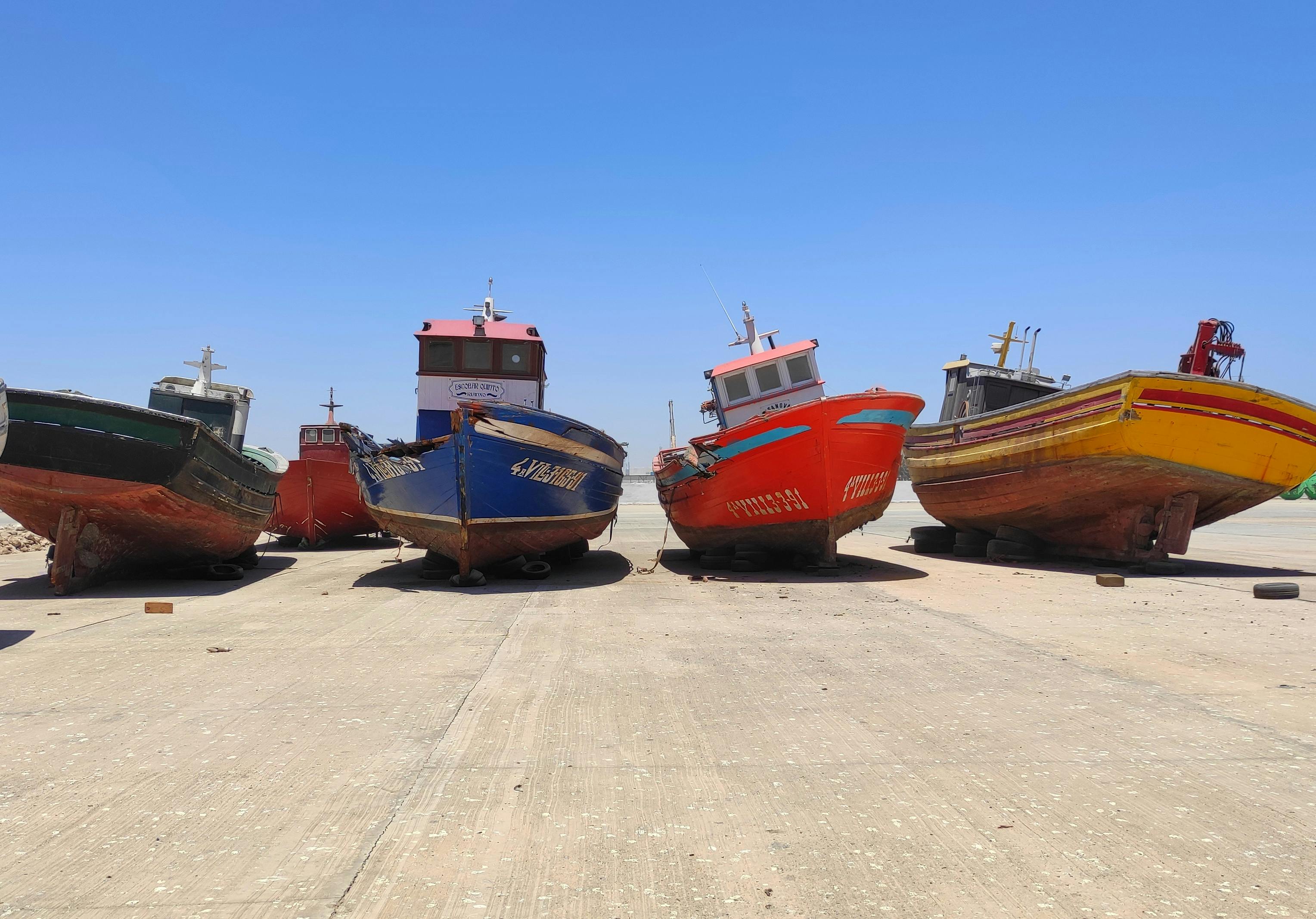 Traditional fishing boats moored at a port on Mauritania's coast