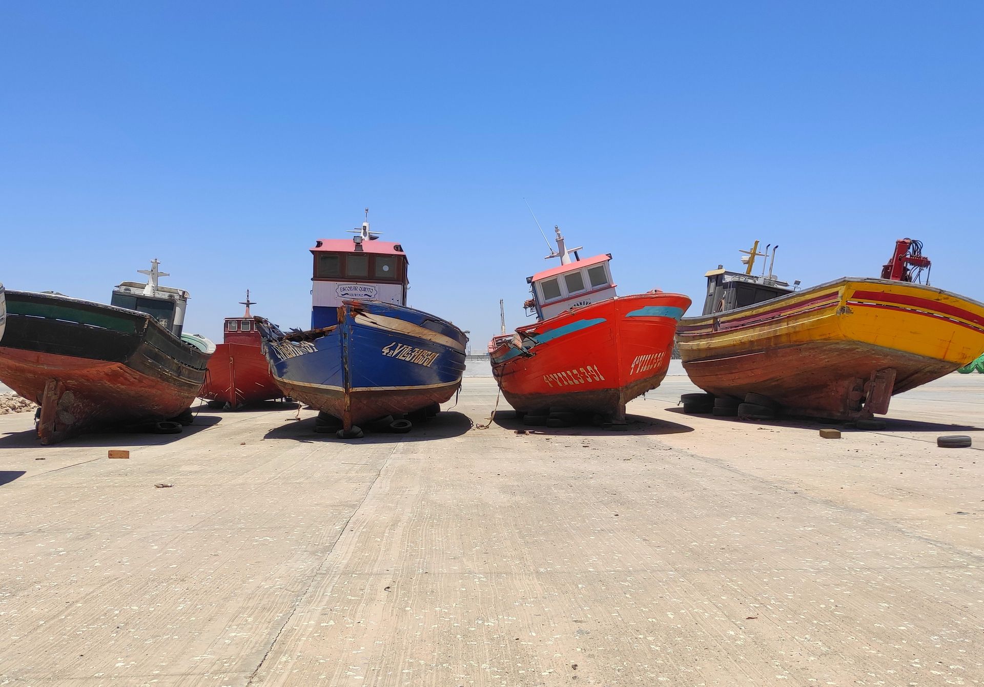 Traditional fishing boats moored at a port on Mauritania's coast