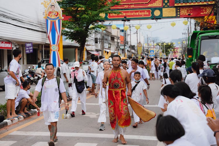 People In Traditional Clothes On City Street Festival