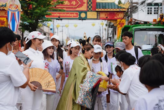 A lively street festival in Thailand showcasing traditional attire and cultural festivities.