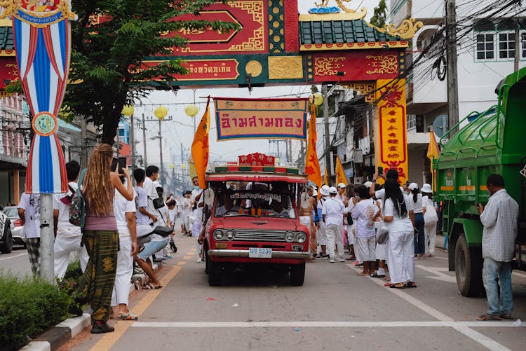 Cars Driving Street During City Festival In Thailand