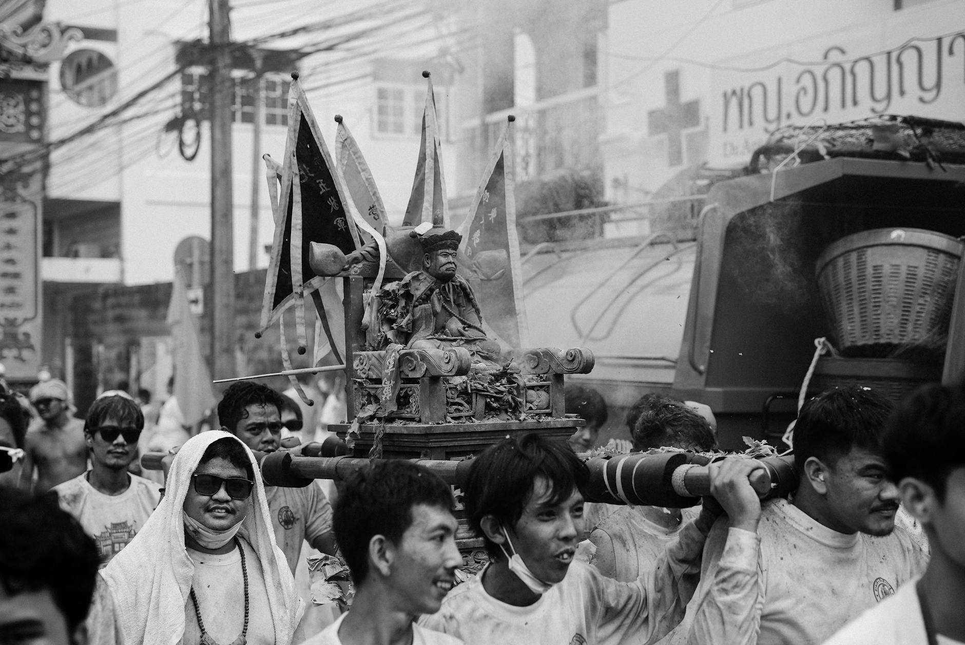 Men carrying a sculpture during a street festival
