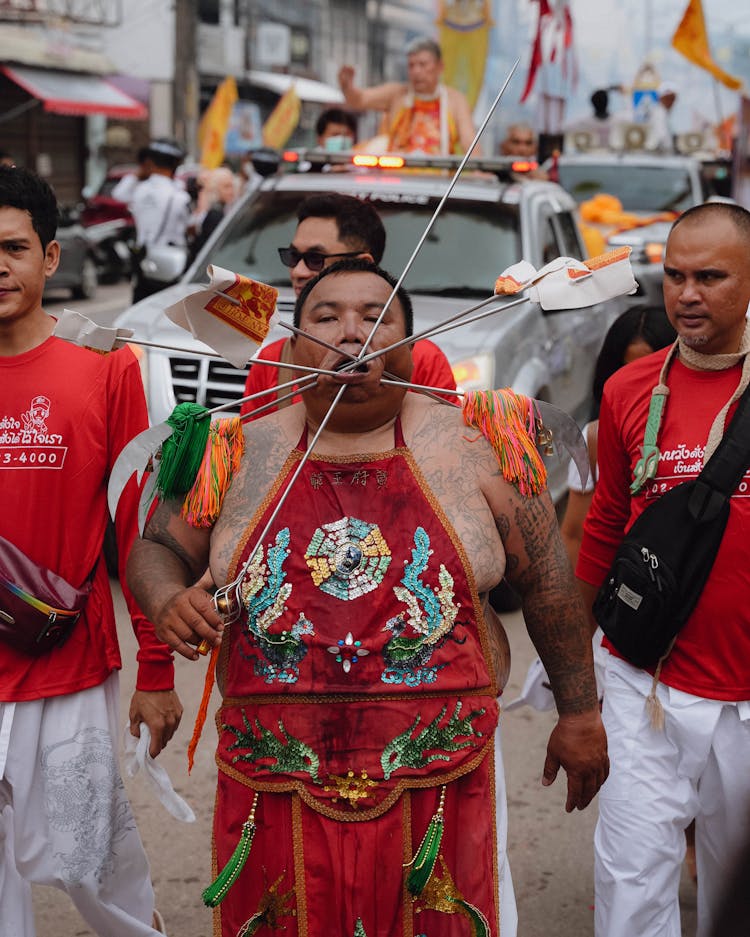 Man In Traditional Clothing With Cheek Piercing On Festival