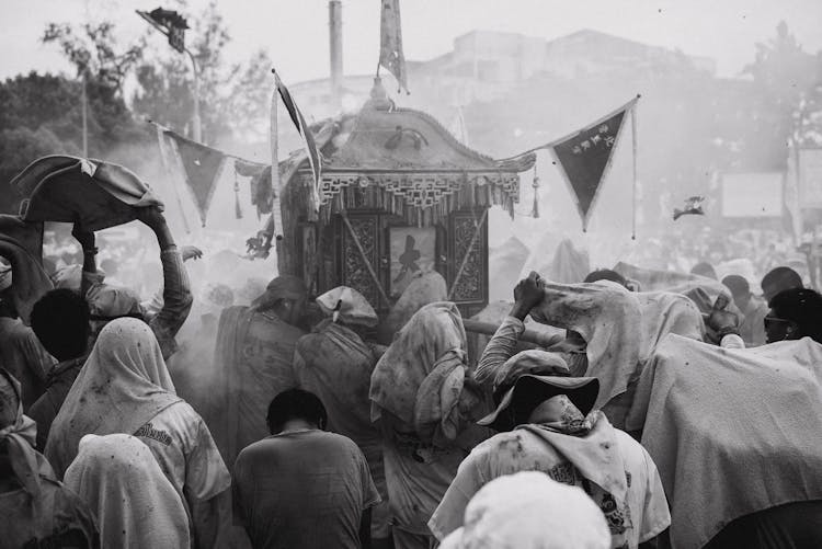 People Carrying Statue During City Festival