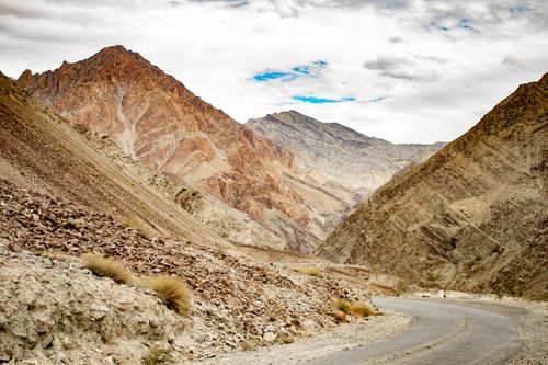 Free Explore the rugged beauty of Sanjak's mountainous landscape with a winding road and dramatic skies. Stock Photo