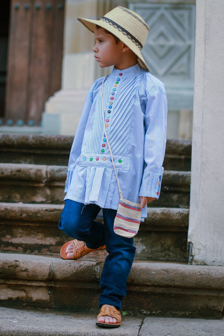 A Boy Wearing Blue Top Looking Sideways