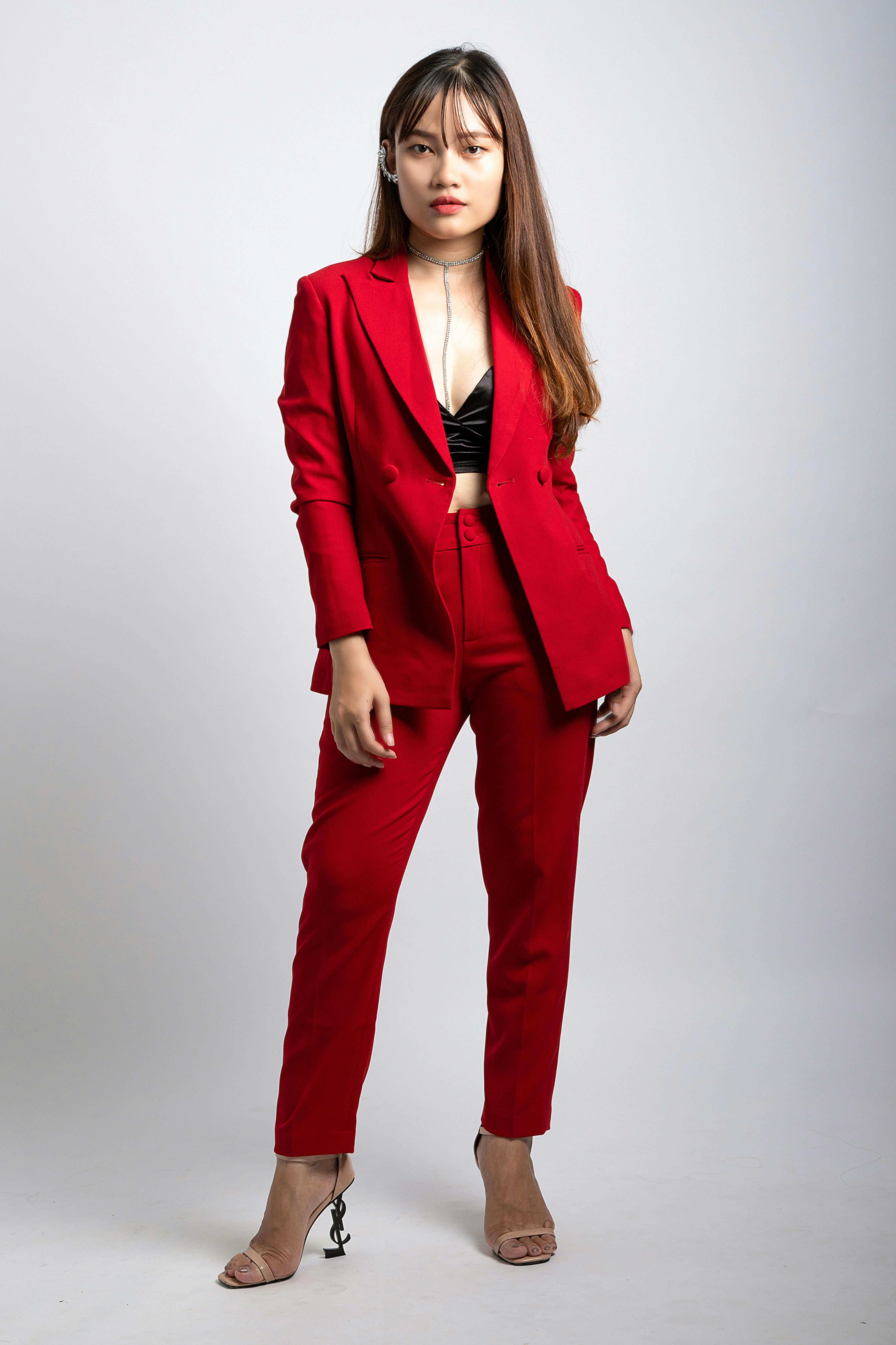Premium Photo  Stylish woman in a beige coat and red pants