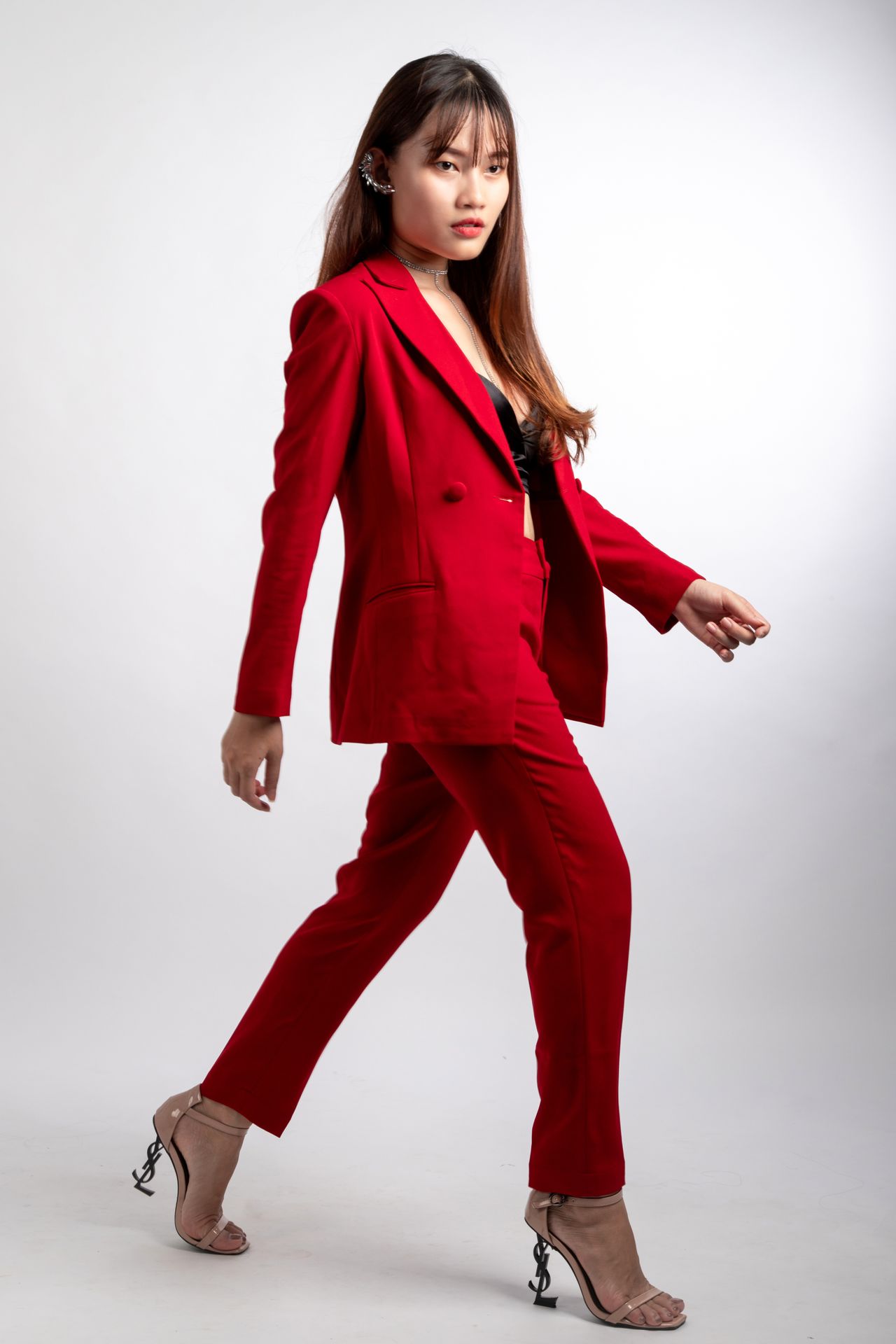 Woman in a red suit with statement heels