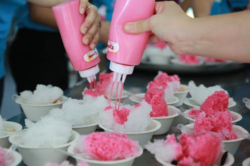 Free Person Pouring Pink Liquid on Ice Stock Photo