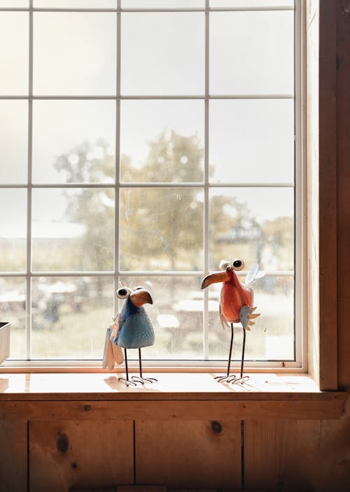 Cute Handmade Figurines of Birds Standing on a Windowsill 