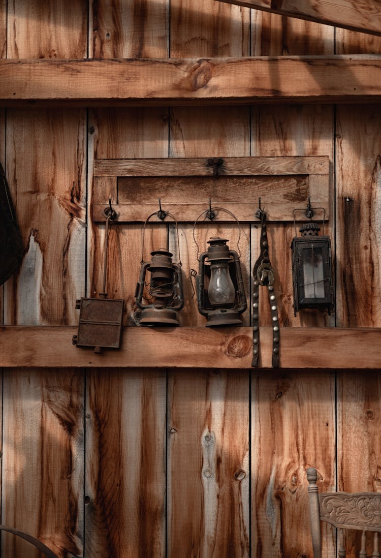 Vintage Lanterns Hanging On Wooden Wall