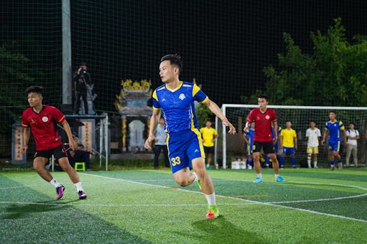 Energetic soccer match with athletes in action on a night-lit local field.