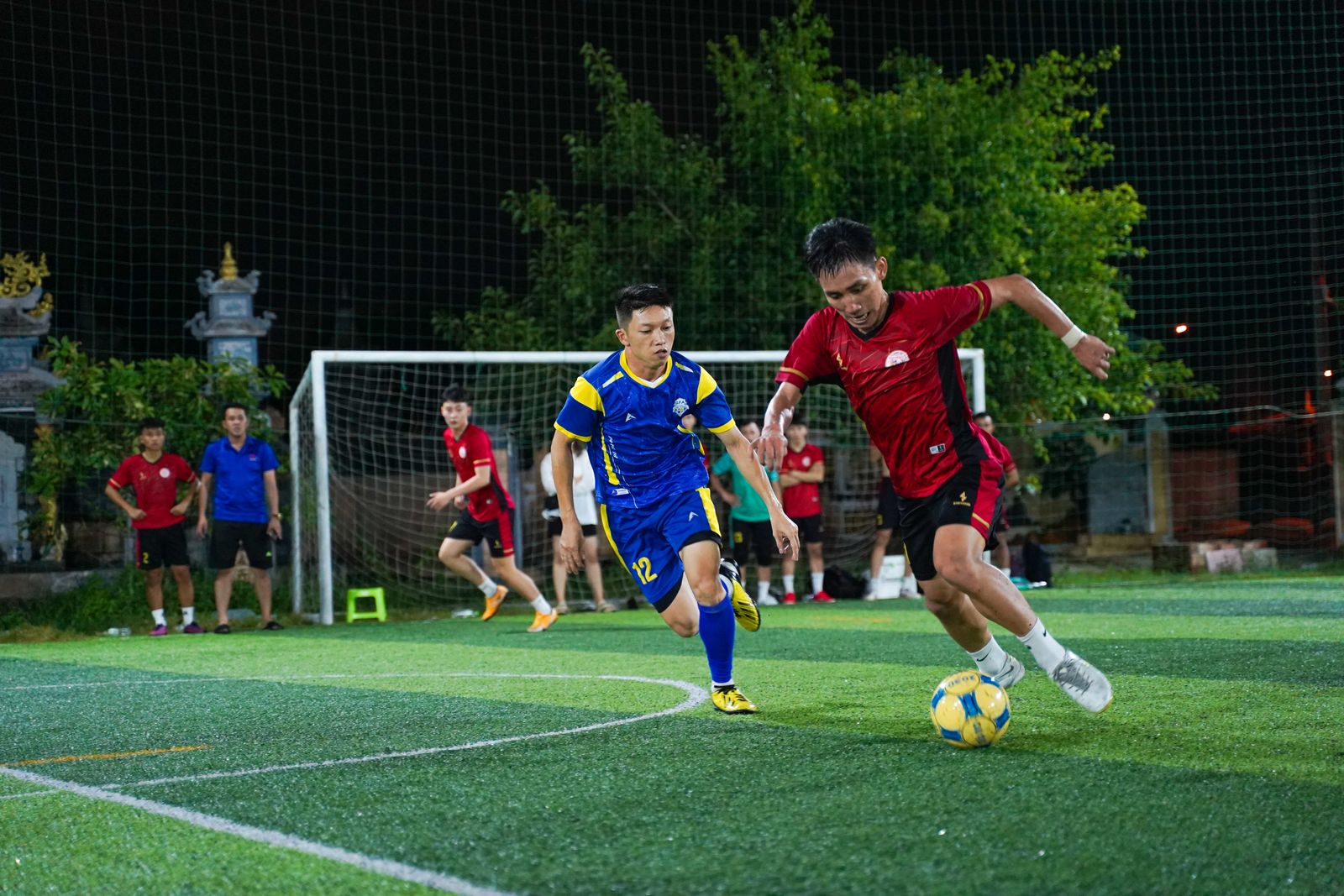 Players competing in a five-a-side football match