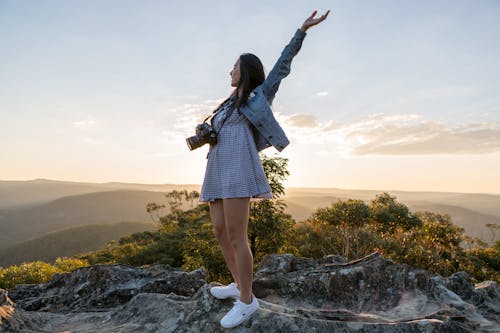 Free Woman in Gray Dress on Top of Mountain Stock Photo