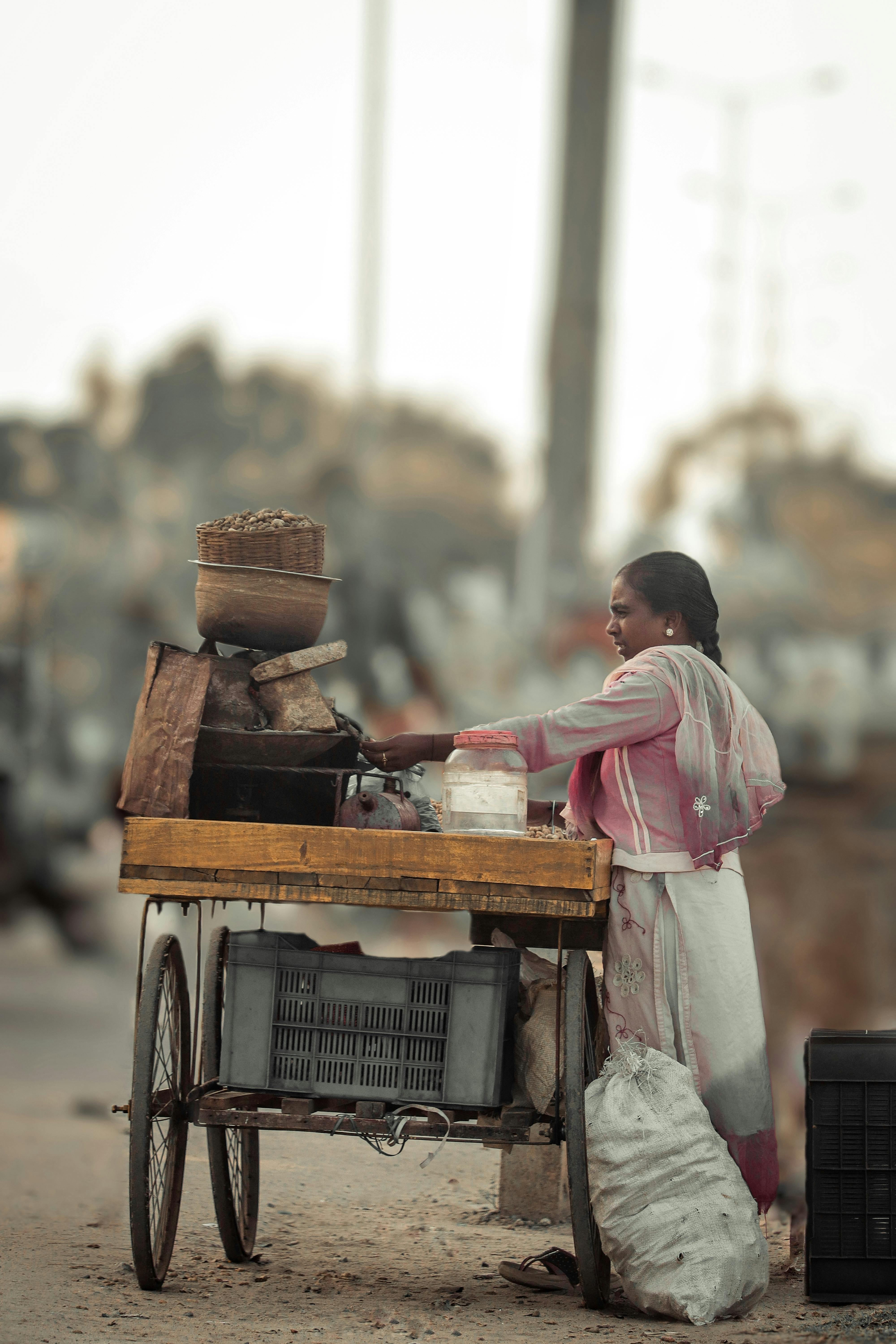 young woman standing behind a selling cart