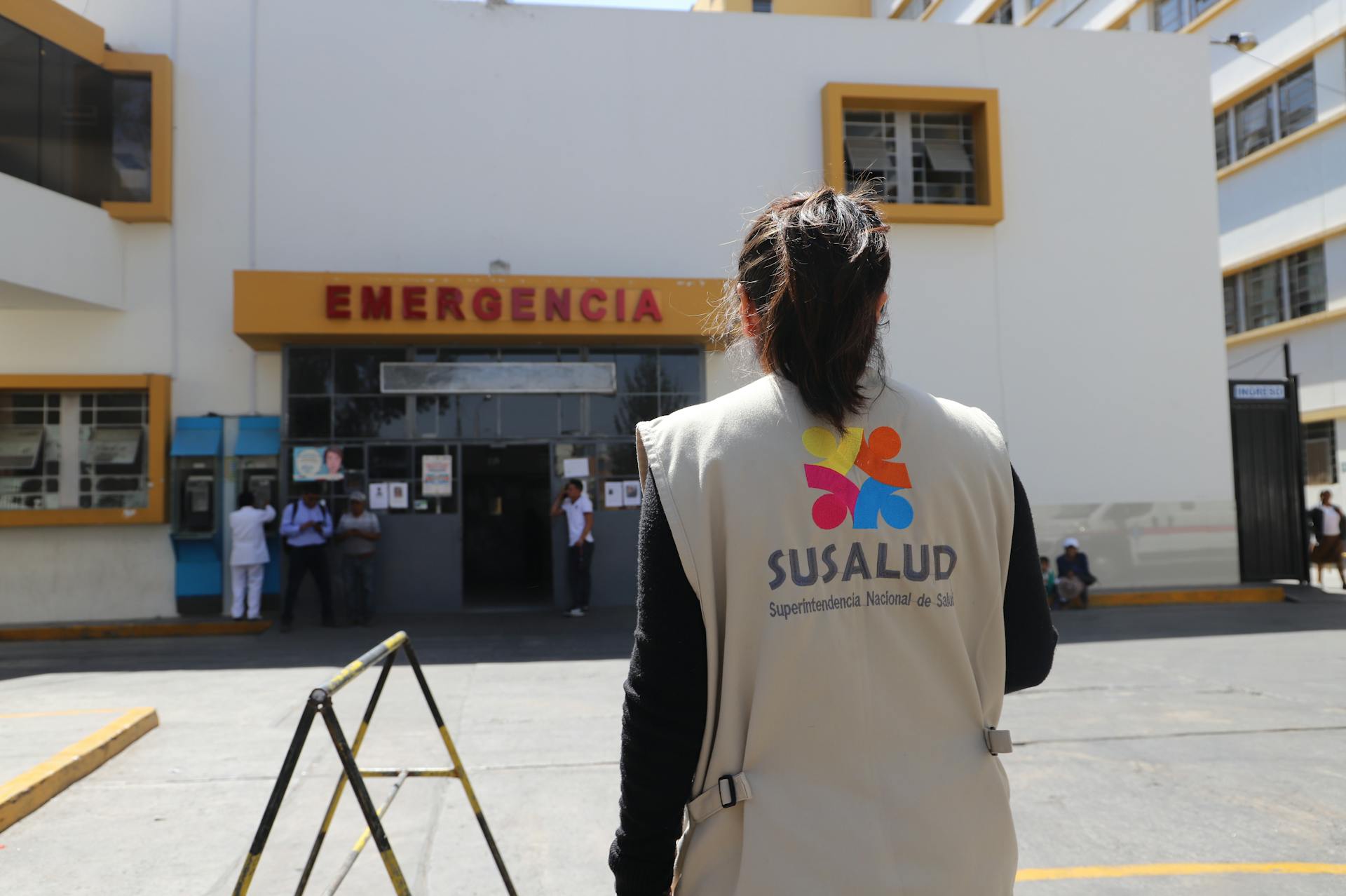 A Woman Standing in Front of a Hospital